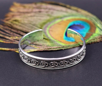 Unisex 925 sterling silver "AUM" Mantra cuff bangle bracelet with oxidized finish, adjustable design, handcrafted tribal jewelry.