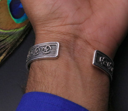 Sterling silver AUM Mantra cuff bracelet by TRIBAL ORNAMENTS, unisex adjustable oxidized jewelry with intricate design.