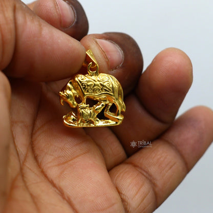 Sterling silver Kamdhenu cow with calf pendant by TRIBAL ORNAMENTS, featuring gold-polished details, handmade elegant jewelry piece.