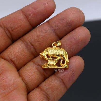 Sterling silver Kamdhenu cow with calf pendant by Tribal Ornaments, gold-polished, handcrafted jewelry with intricate details.