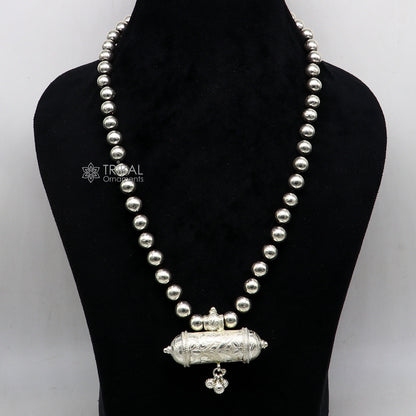 Sterling silver ethnic tribal pendant with wax-filled beads on traditional beaded choker, perfect for brides or cultural jewelry.