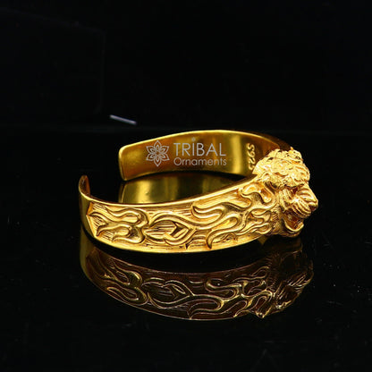 Sterling silver lion face cuff bracelet by TRIBAL ORNAMENTS, vintage style men's jewelry with gold polish and solid design.