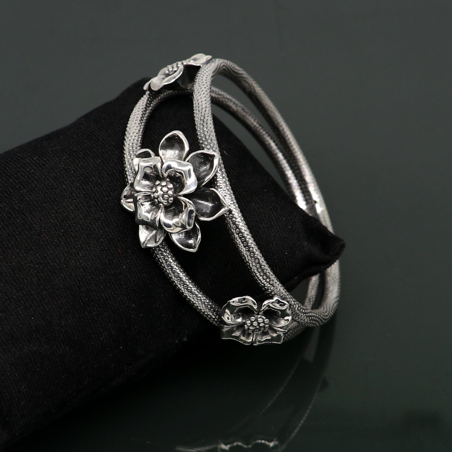 Sterling silver handmade floral vintage bangle bracelet by TRIBAL ORNAMENTS, showcasing intricate flower work and traditional wedding jewelry style.