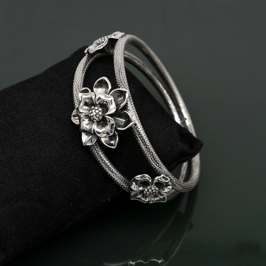 Sterling silver handmade floral vintage bangle bracelet by TRIBAL ORNAMENTS, showcasing intricate flower work and traditional wedding jewelry style.
