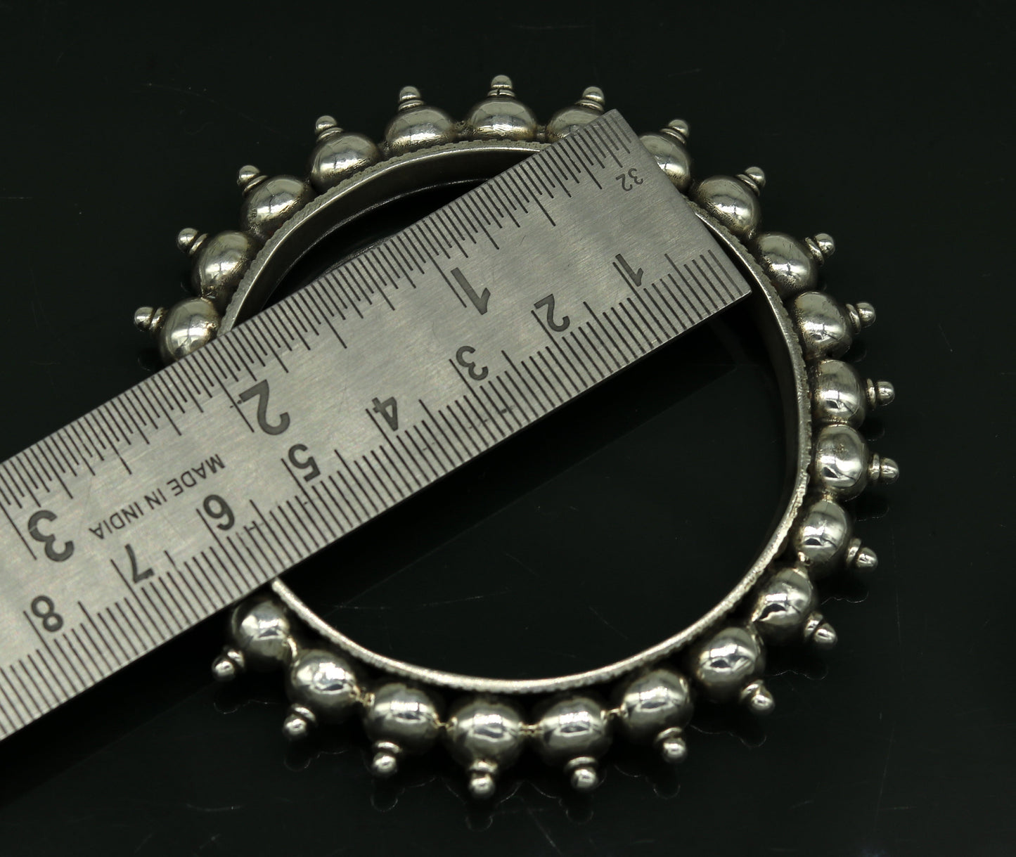 Sterling silver handmade vintage bangle bracelet with intricate tribal design, ideal for weddings or personalized jewelry gifts.