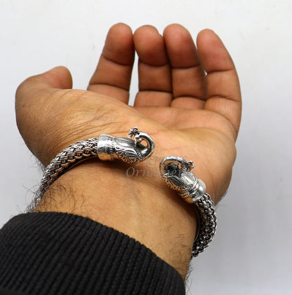 Sterling silver handmade vintage peacock bangle bracelet by TRIBAL ORNAMENTS, unisex customized hip-hop jewelry with intricate peacock design.