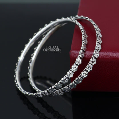 Sterling silver floral bangle bracelet by TRIBAL ORNAMENTS with intricate handmade design, perfect for bridal or gift jewelry.