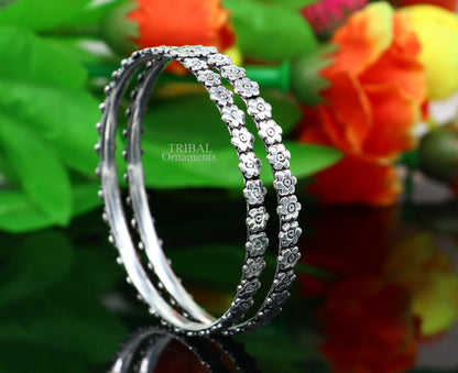 Sterling silver floral bangle bracelet by TRIBAL ORNAMENTS, featuring intricate handmade floral design perfect for bridal jewelry.