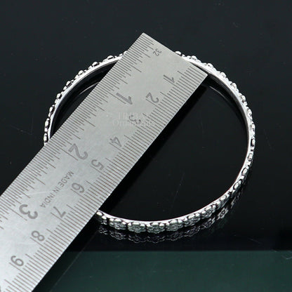 Sterling silver floral bangle bracelet by TRIBAL ORNAMENTS with intricate handmade design, perfect for brides or gifting.