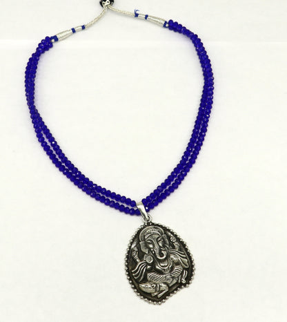 Sterling silver tribal necklace with blue agate stone beads and Ganesha pendant, featuring an adjustable design and intricate temple jewelry style.