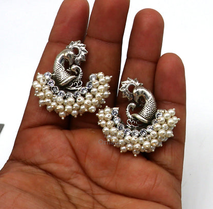 Sterling silver peacock design stud earring with cut stone and pearl, handcrafted tribal jewelry by TRIBAL ORNAMENTS.