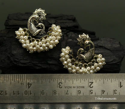 Sterling silver peacock design stud earring with pearl stone, handcrafted tribal jewelry by Tribal Ornaments.