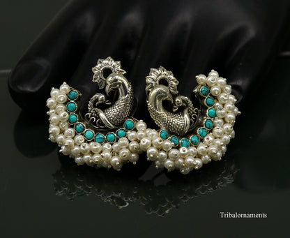 Sterling silver handmade peacock design stud earring with turquoise and pearl accents, tribal jewelry by TRIBAL ORNAMENTS.