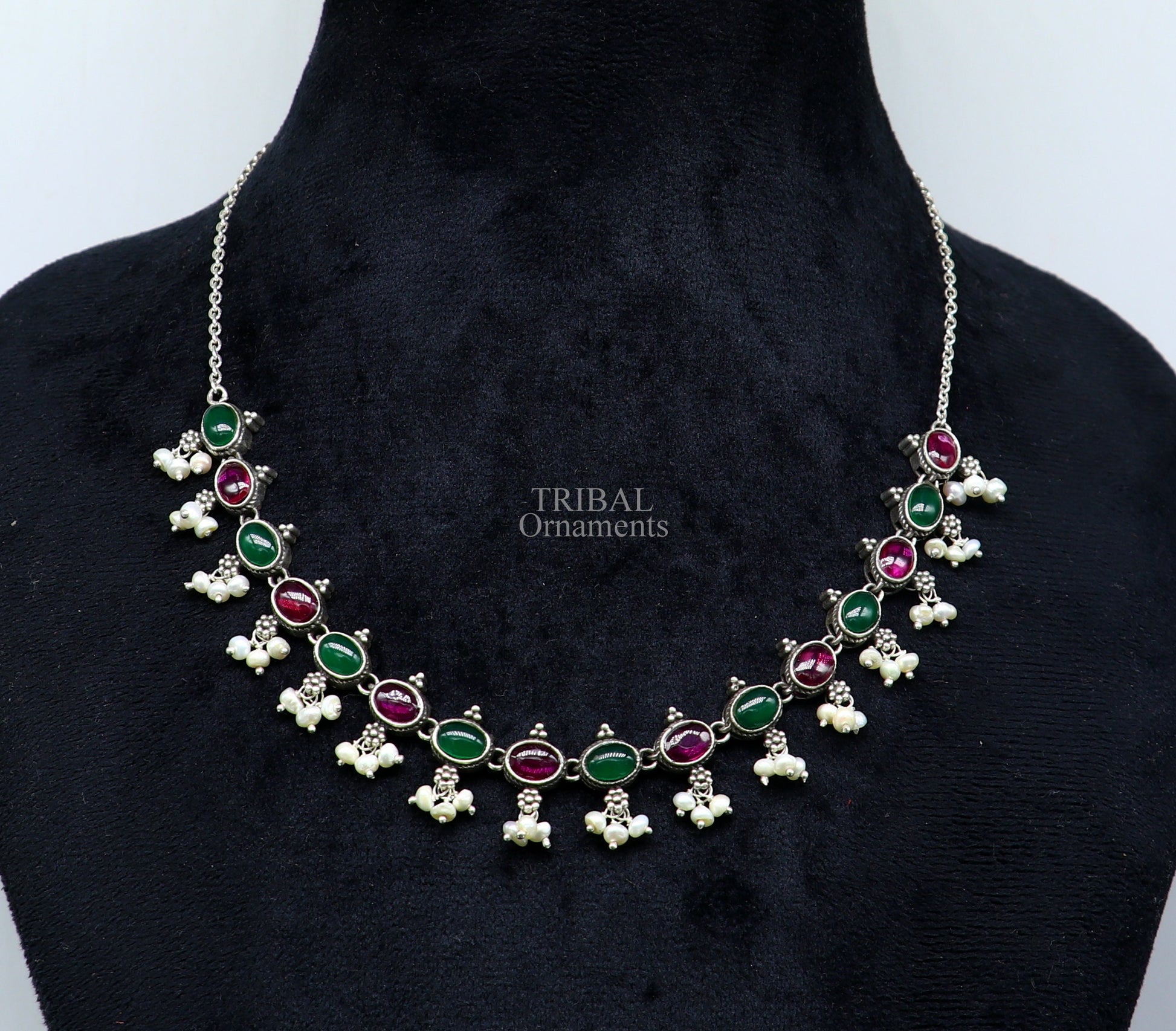 Sterling silver necklace with red and green stones, pearls, and intricate tribal design, ideal for wedding or bridal jewelry.