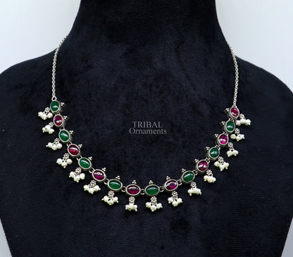 Sterling silver necklace with red and green stones, pearls, and intricate tribal design, ideal for wedding or bridal jewelry.