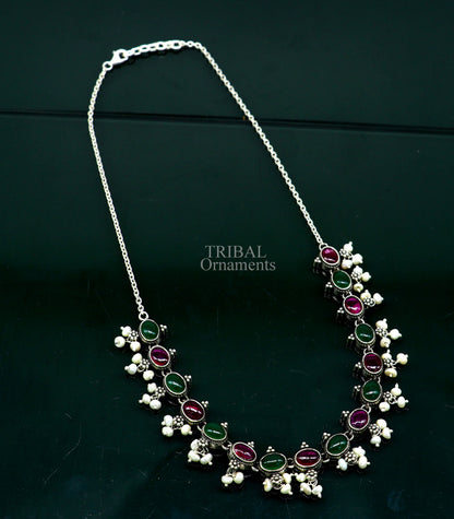 Sterling silver necklace with red and green stones, pearls, and intricate tribal design, perfect for wedding or bridal jewelry.