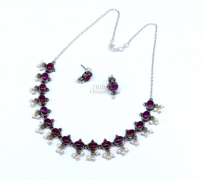 Sterling silver vintage necklace with red stone and pearls, featuring a stylish bride charm and intricate handmade design.