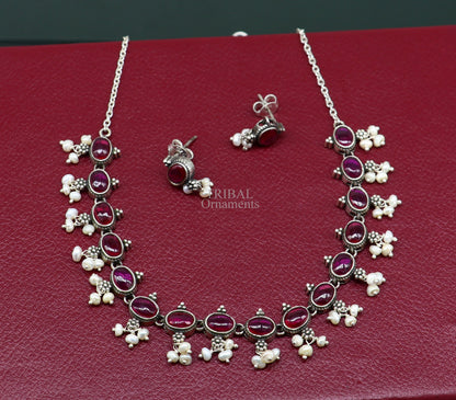 Sterling silver necklace with red stone and pearl accents, vintage-styled wedding jewelry set featuring intricate craftsmanship and charming design.