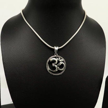 Sterling silver OM mantra pendant by TRIBAL ORNAMENTS featuring intricate Hindu-inspired design, unisex and handcrafted jewelry.