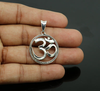 Sterling silver OM mantra pendant by TRIBAL ORNAMENTS, handmade unisex Hindu jewelry with intricate tribal design.