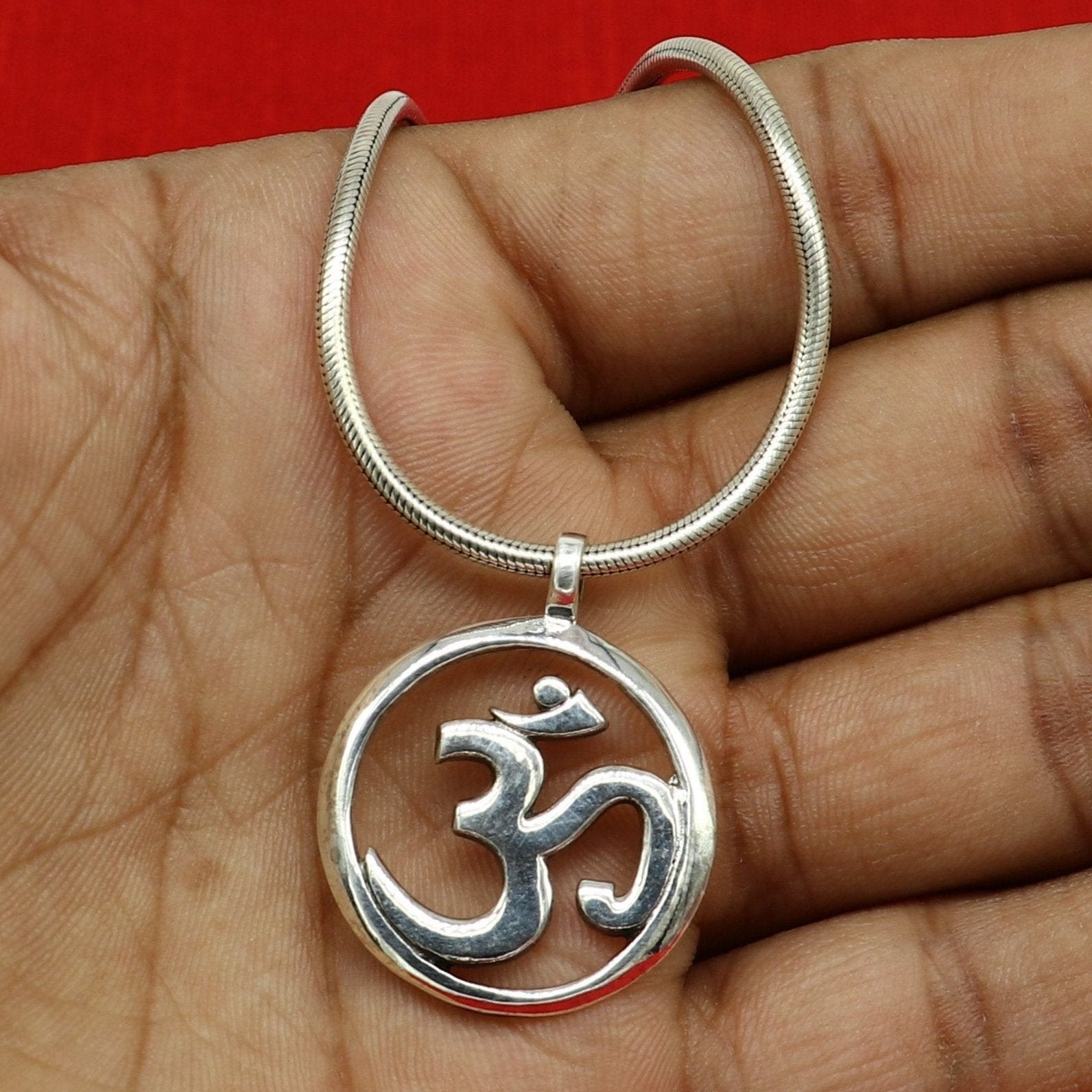 Sterling silver Hindu mantra 'Aum' OM pendant, unisex tribal jewelry, handmade and stylish, featuring intricate tribal design.