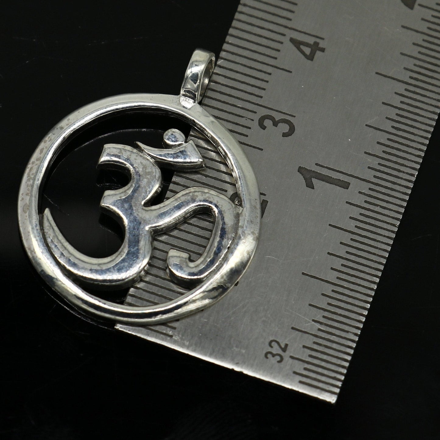 Sterling silver Hindu mantra 'Aum' OM pendant, unisex jewelry by TRIBAL ORNAMENTS, featuring intricate tribal design and handcrafted detail.
