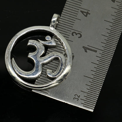 Sterling silver Hindu mantra 'Aum' OM pendant, unisex jewelry by TRIBAL ORNAMENTS, featuring intricate tribal design and handcrafted detail.