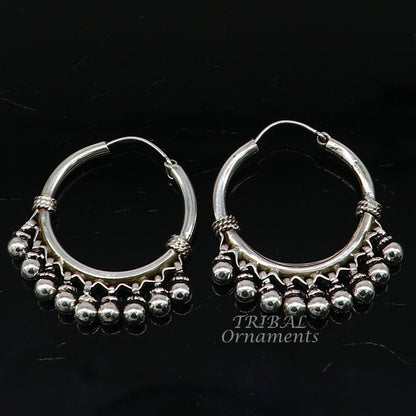 Elegant handmade 925 sterling silver hoop earring with hanging bells, tribal design, hook closure, crafted by TRIBAL ORNAMENTS.