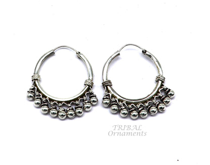 Sterling silver handmade hoop earring with hanging Bali bells and hook, featuring tribal design and elegant craftsmanship.