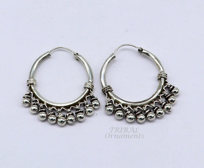 Sterling silver handmade hoop earring with hanging bells and hook, elegant tribal jewelry from TRIBAL ORNAMENTS.