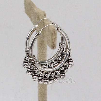 Sterling silver handmade hoop earring with hanging bells, hook design, featuring tribal-inspired jewelry from TRIBAL ORNAMENTS.