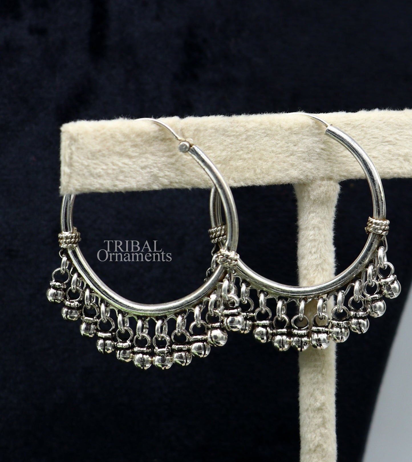 Sterling silver handmade hoop earring with hanging bells, tribal design by TRIBAL ORNAMENTS, perfect for gifting or everyday wear.