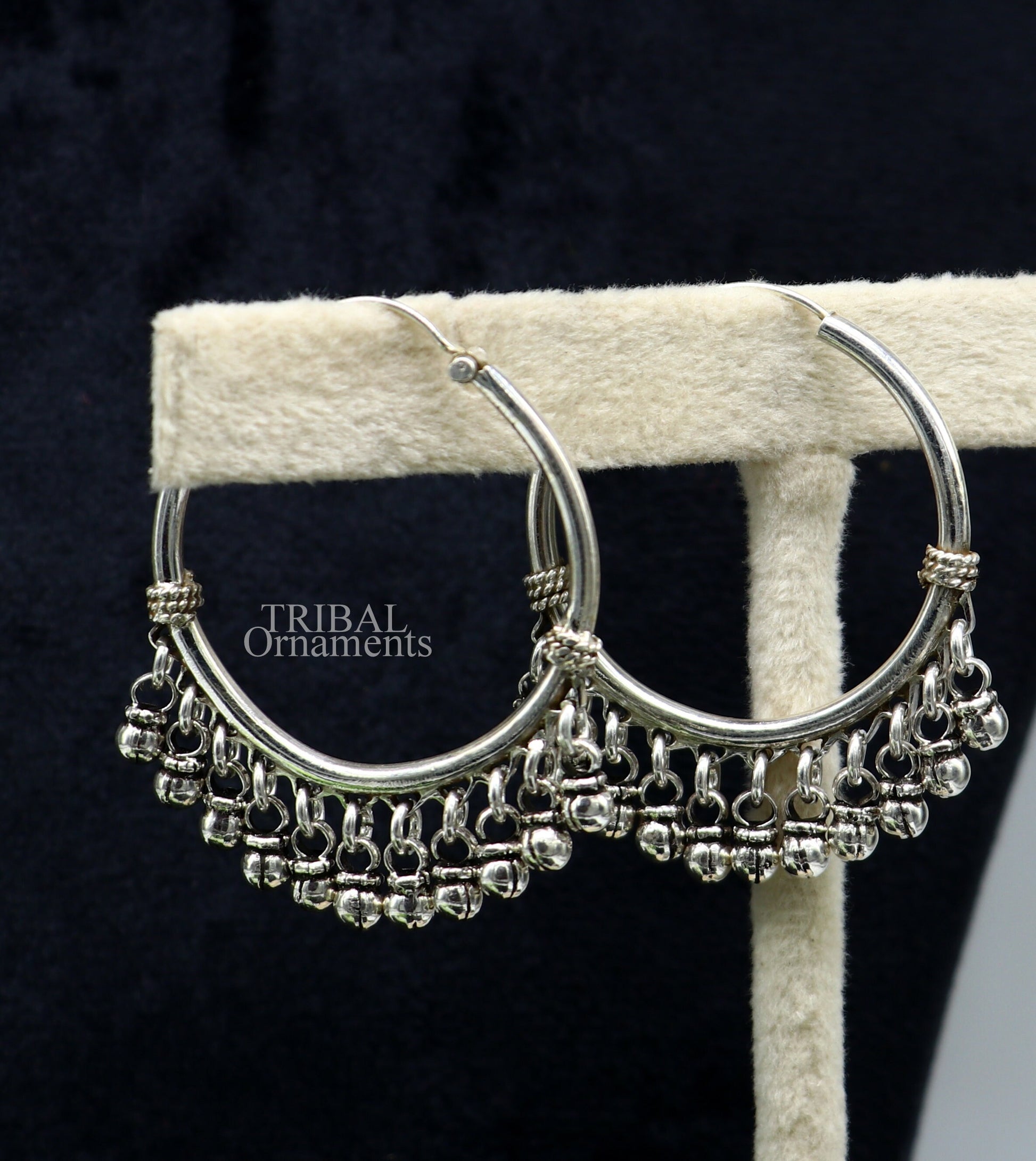 Sterling silver handmade hoop earring with hanging bells, tribal design by TRIBAL ORNAMENTS, perfect for gifting or everyday wear.