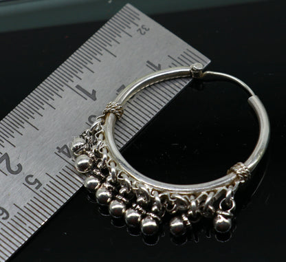 925 sterling silver handmade hoop earring with Bali hanging bells and hook, featuring tribal-inspired design and custom jewelry details.
