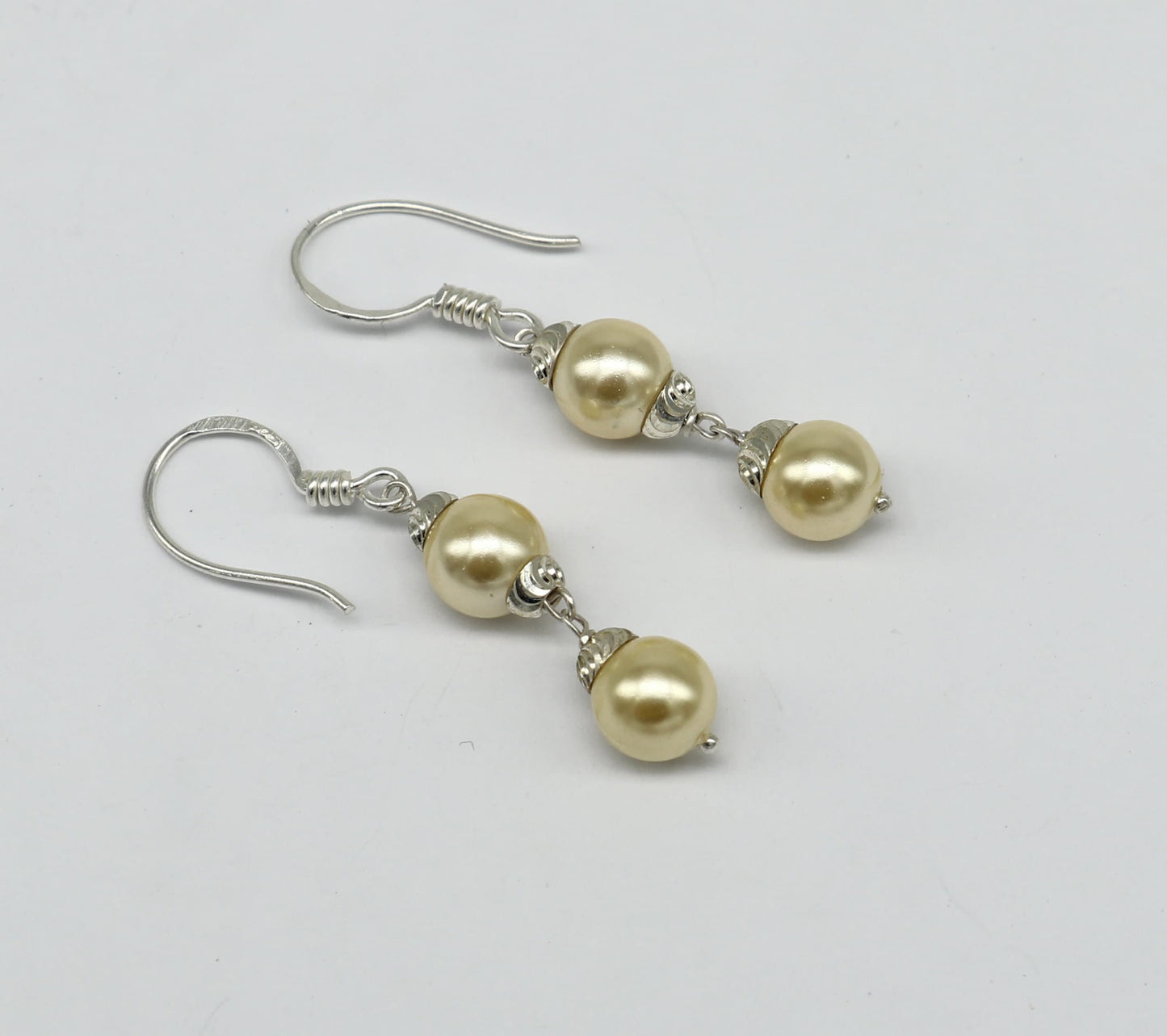 Sterling silver handmade hoop earrings with dangling pearls, designed for bridesmaids, featuring a customized hook style.
