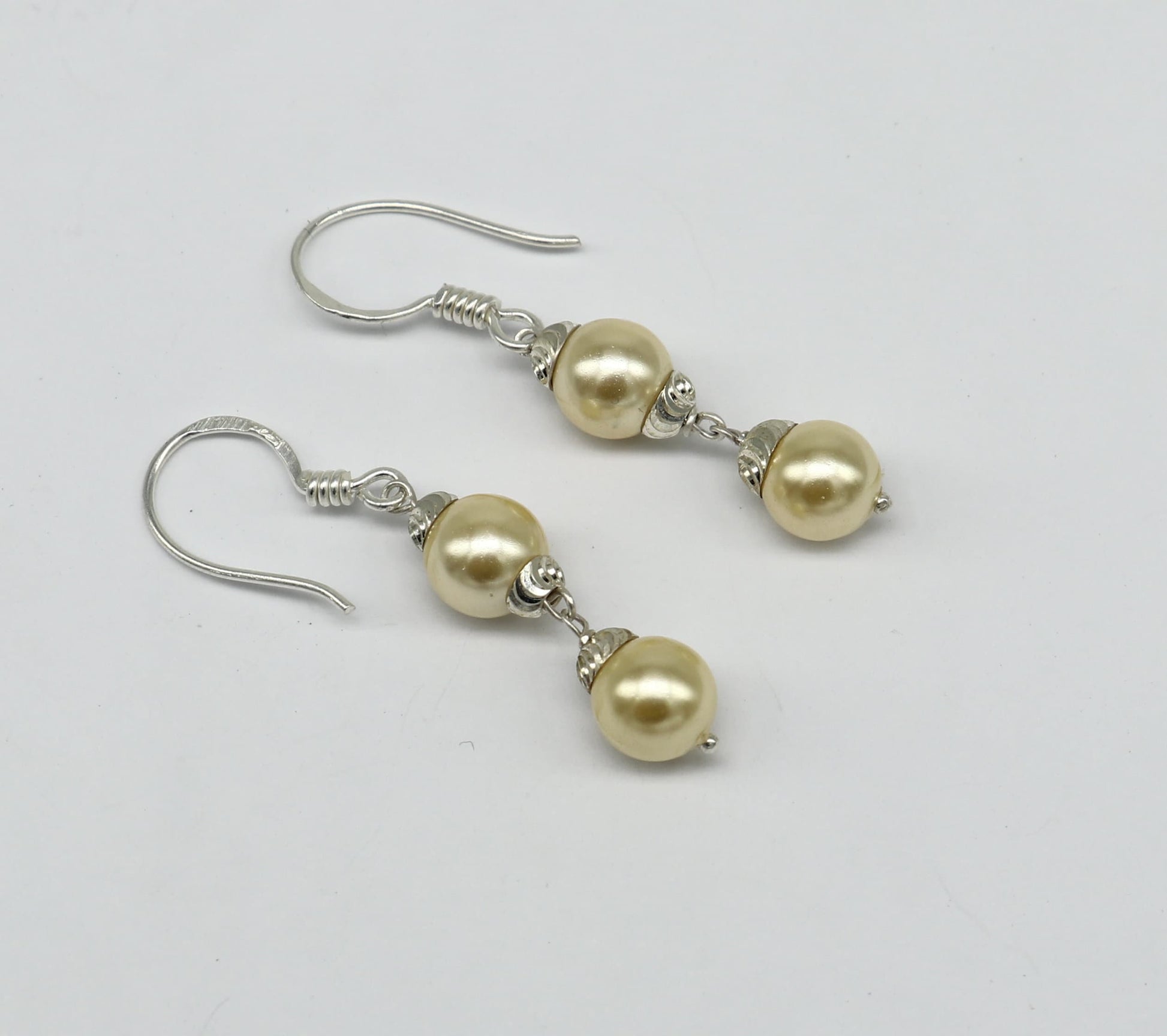 Sterling silver handmade hoop earrings with dangling pearls, designed for bridesmaids, featuring a customized hook style.