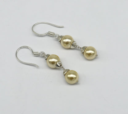 Sterling silver handmade hoop earrings with dangling pearls, designed for bridesmaids, featuring a customized hook style.