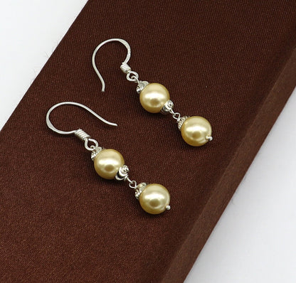 Sterling silver handmade pearl hoop earrings with drop design, perfect for bridesmaids and special occasions by TRIBAL ORNAMENTS.
