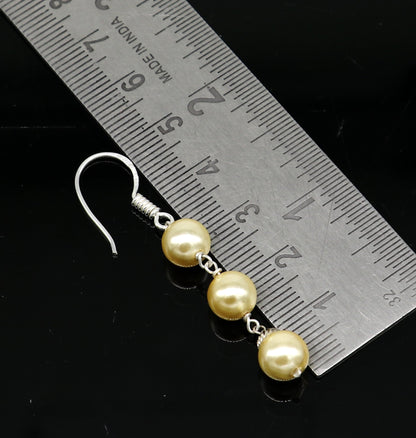 Sterling silver handmade hoop earrings with dangling pearls, perfect for bridesmaids and special occasions.