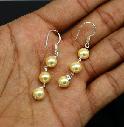 Sterling silver handmade hoop earrings with dangling pearls, perfect for bridesmaids and special occasions, by Tribal Ornaments.