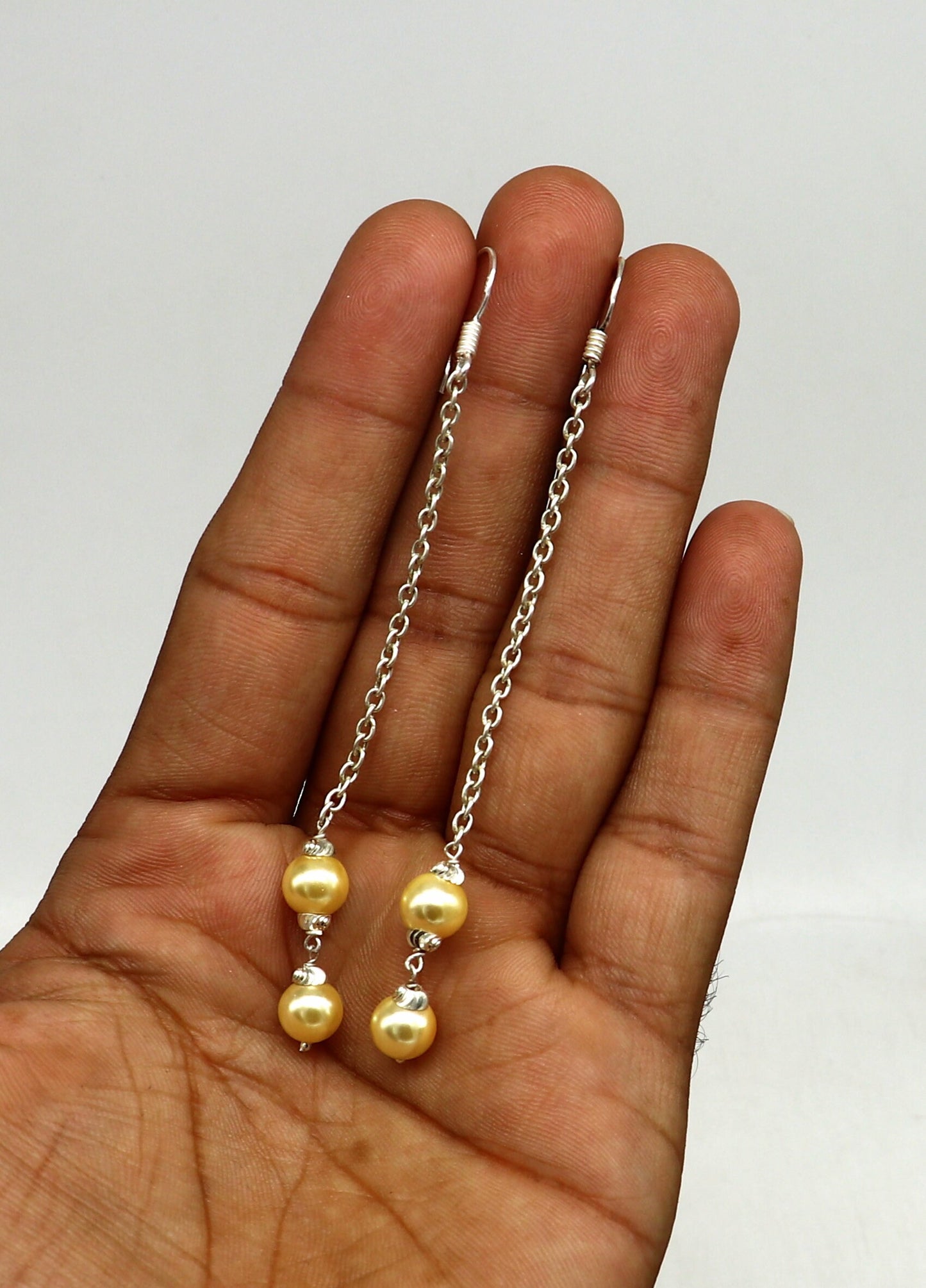 Sterling silver handmade pearl hoop earrings with drop design and customized hooks, perfect for bridesmaids and special occasions.
