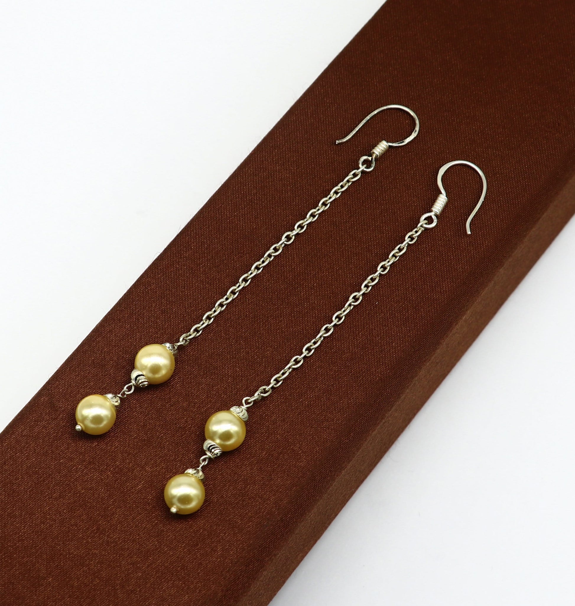 Sterling silver handmade hoop earrings with dangling pearls, perfect for bridesmaids, featuring a customized hook design.