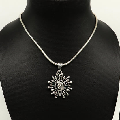 Sterling silver Ganesha floral pendant by TRIBAL ORNAMENTS, handmade unisex jewelry with detailed idol design and floral motifs.