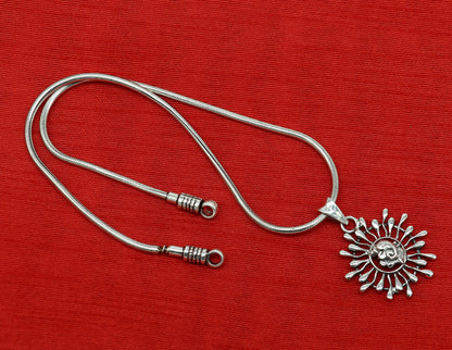 Sterling silver Ganesha floral pendant by TRIBAL ORNAMENTS, handmade unisex jewelry with detailed idol design and intricate floral motifs.