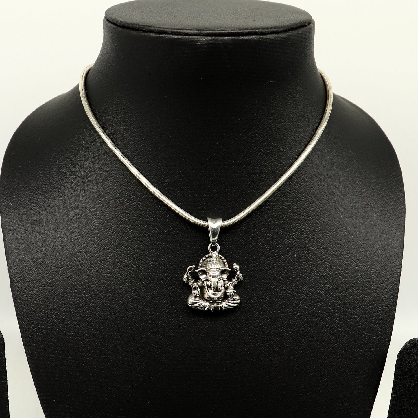 Sterling silver Ganesha pendant by Tribal Ornaments, handmade unisex jewelry with intricate tribal design and personalized style.