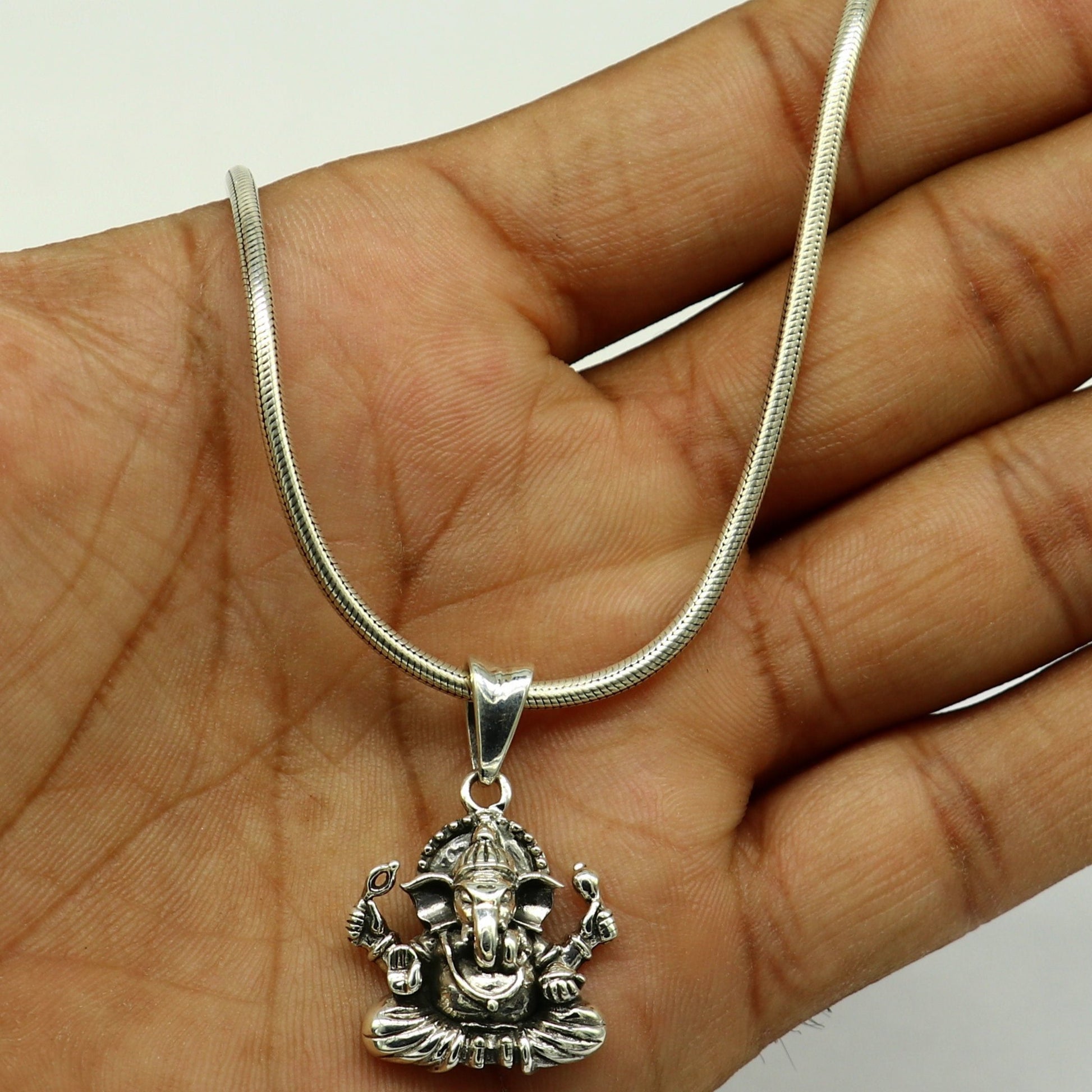 Sterling silver Ganesha pendant by Tribal Ornaments, handmade unisex jewelry with intricate tribal design and personalized style.