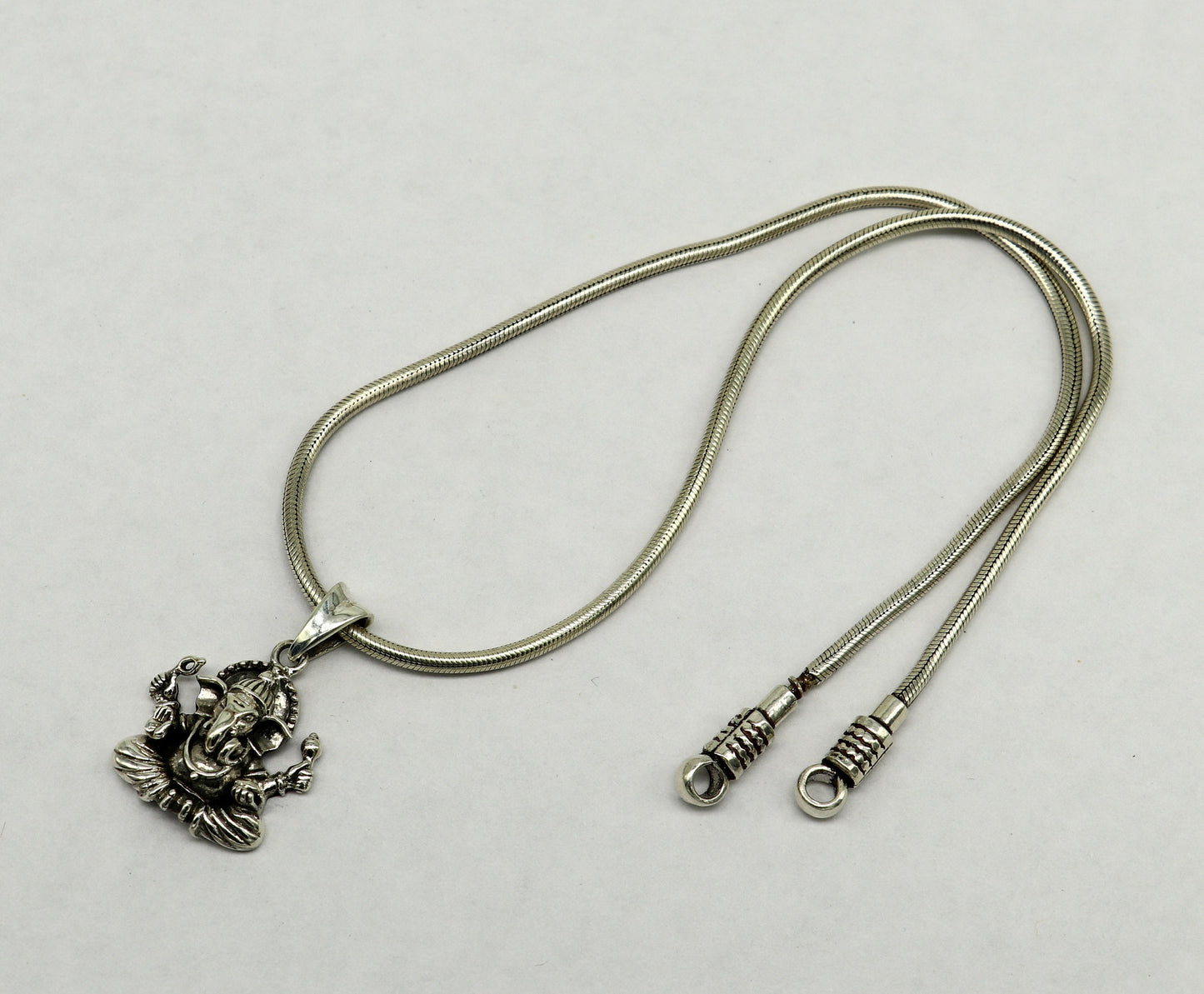 Sterling silver Ganesha pendant, handmade tribal jewelry, unisex personalized idol necklace, intricate design with detailed craftsmanship.