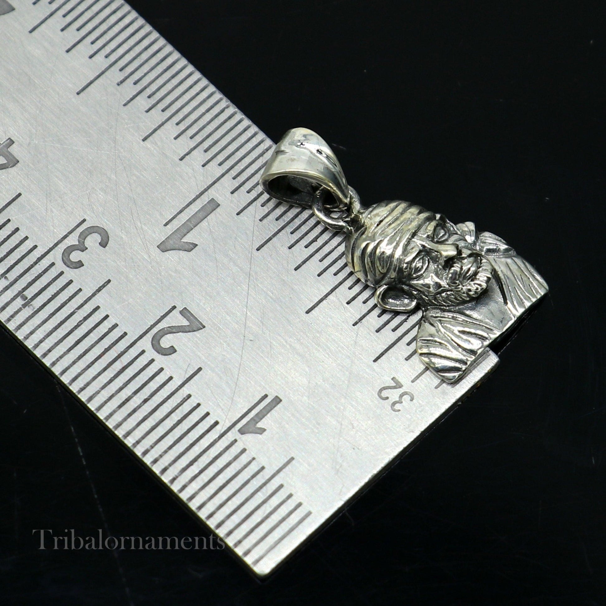 Sterling silver Sai Baba pendant by TRIBAL ORNAMENTS, handcrafted unisex jewelry featuring a divine Indian deity design.
