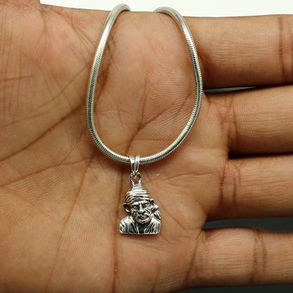 Sterling silver Sai Baba pendant by TRIBAL ORNAMENTS, handmade unisex jewelry featuring detailed idol design and personalized style.