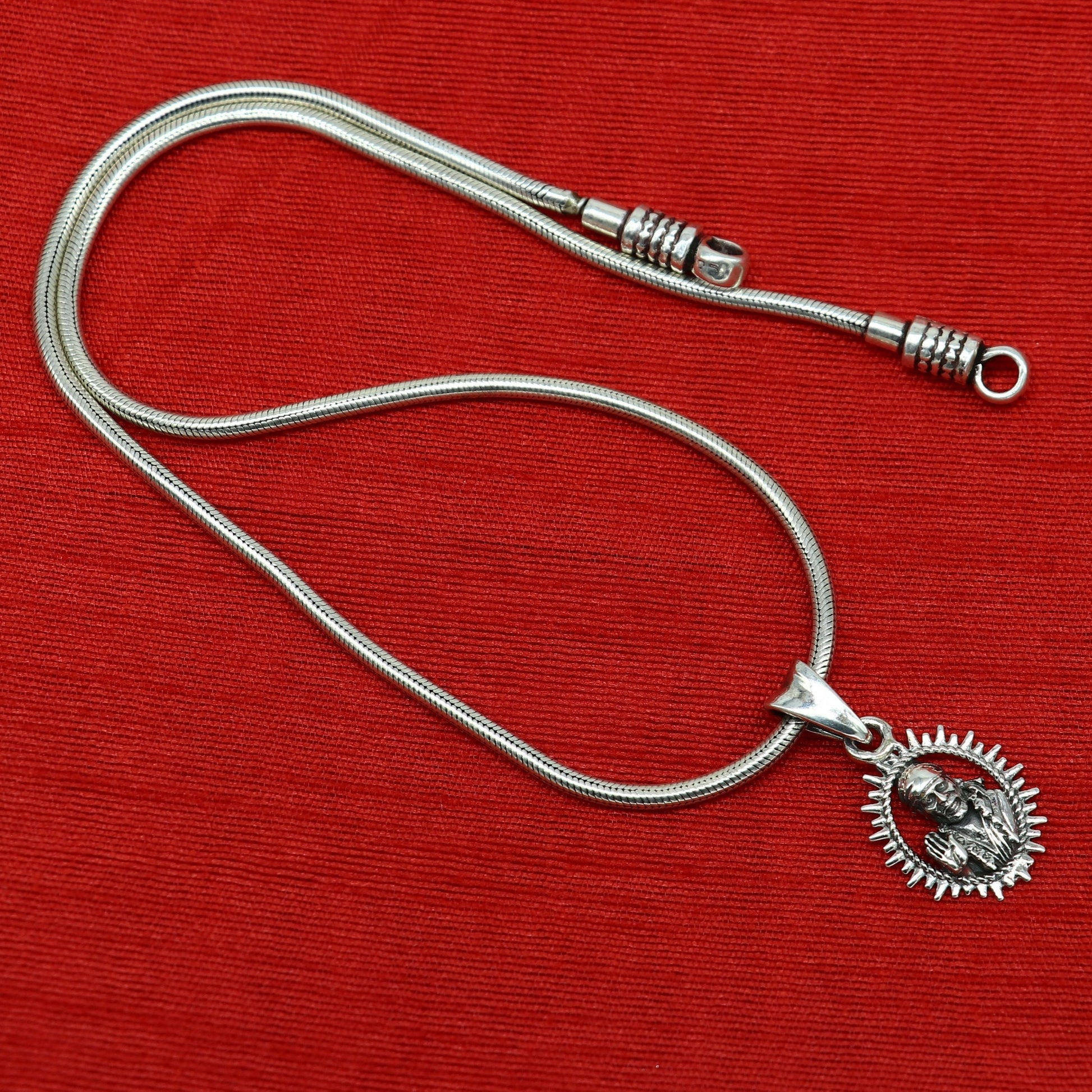 Sterling silver Sai Baba pendant by Tribal Ornaments, handmade Indian-style unisex jewelry with detailed idol design.
